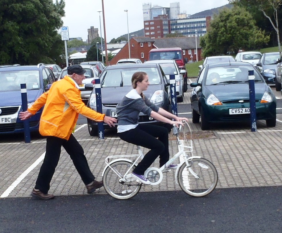 Lady learning to ride.