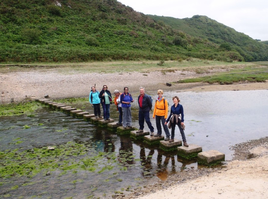 Crossing the Three Cliffs Bay stepping stones.